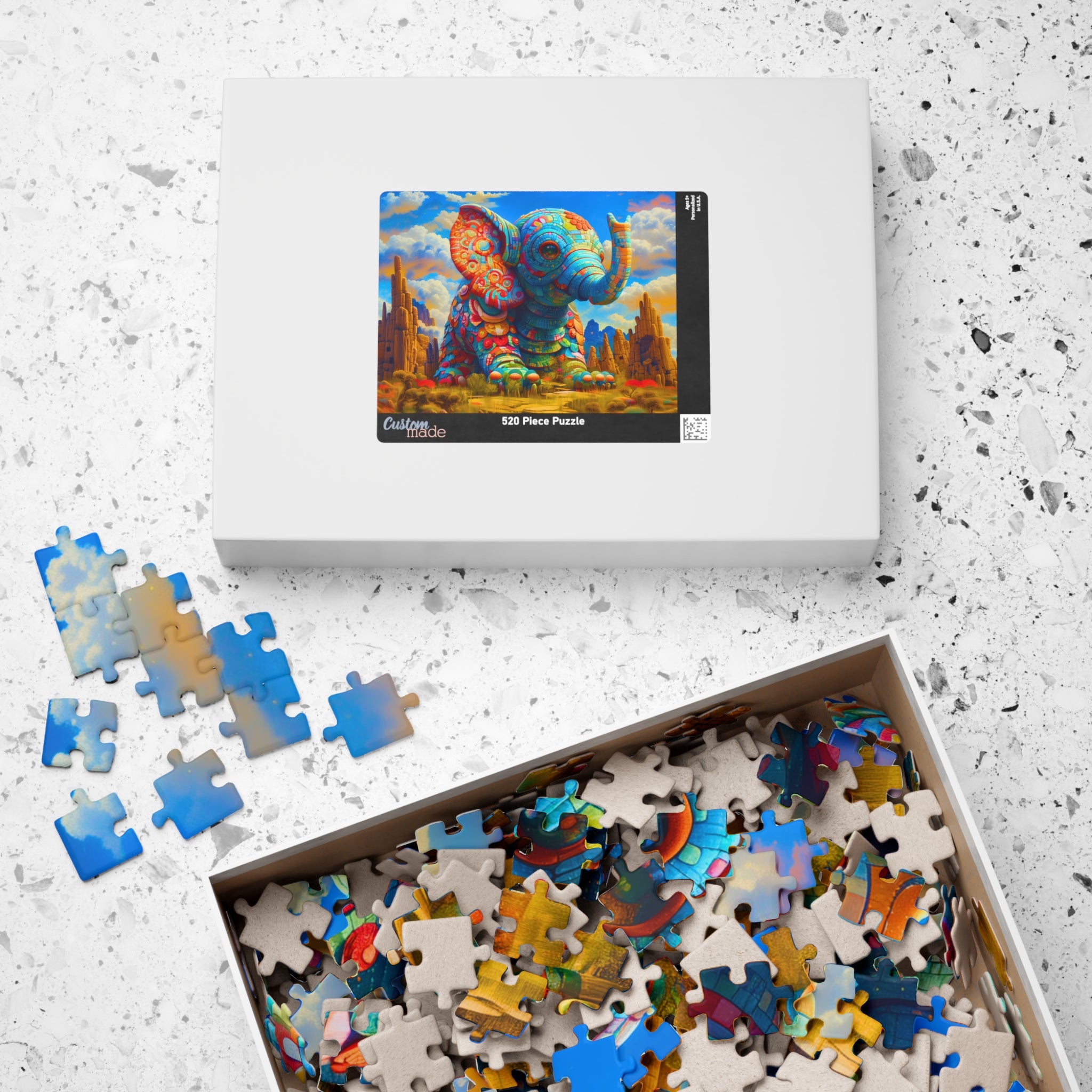 Colorful Elephant puzzle box displayed with vibrant mosaic artwork and colorful puzzle pieces inside, crafted by Printify. This 520 piece art puzzle offers a creative challenge and stunning imagery.