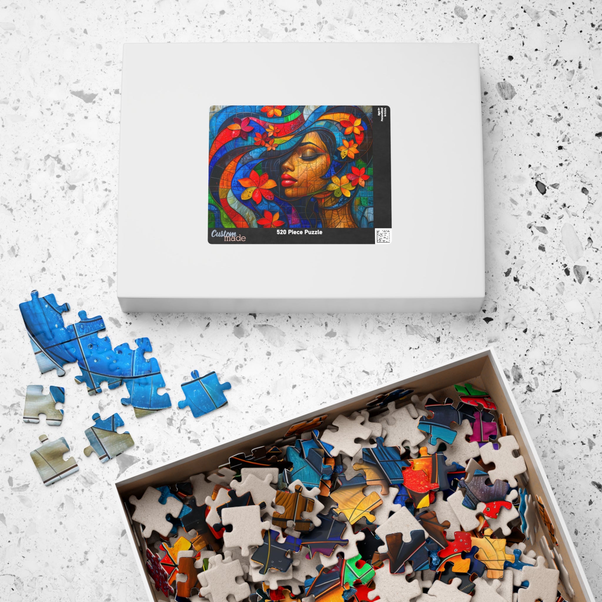 Inside view of the 520 Piece Beauty Queen Art Puzzle box by Printify, revealing colorful puzzle pieces and the stunning art design on the top.