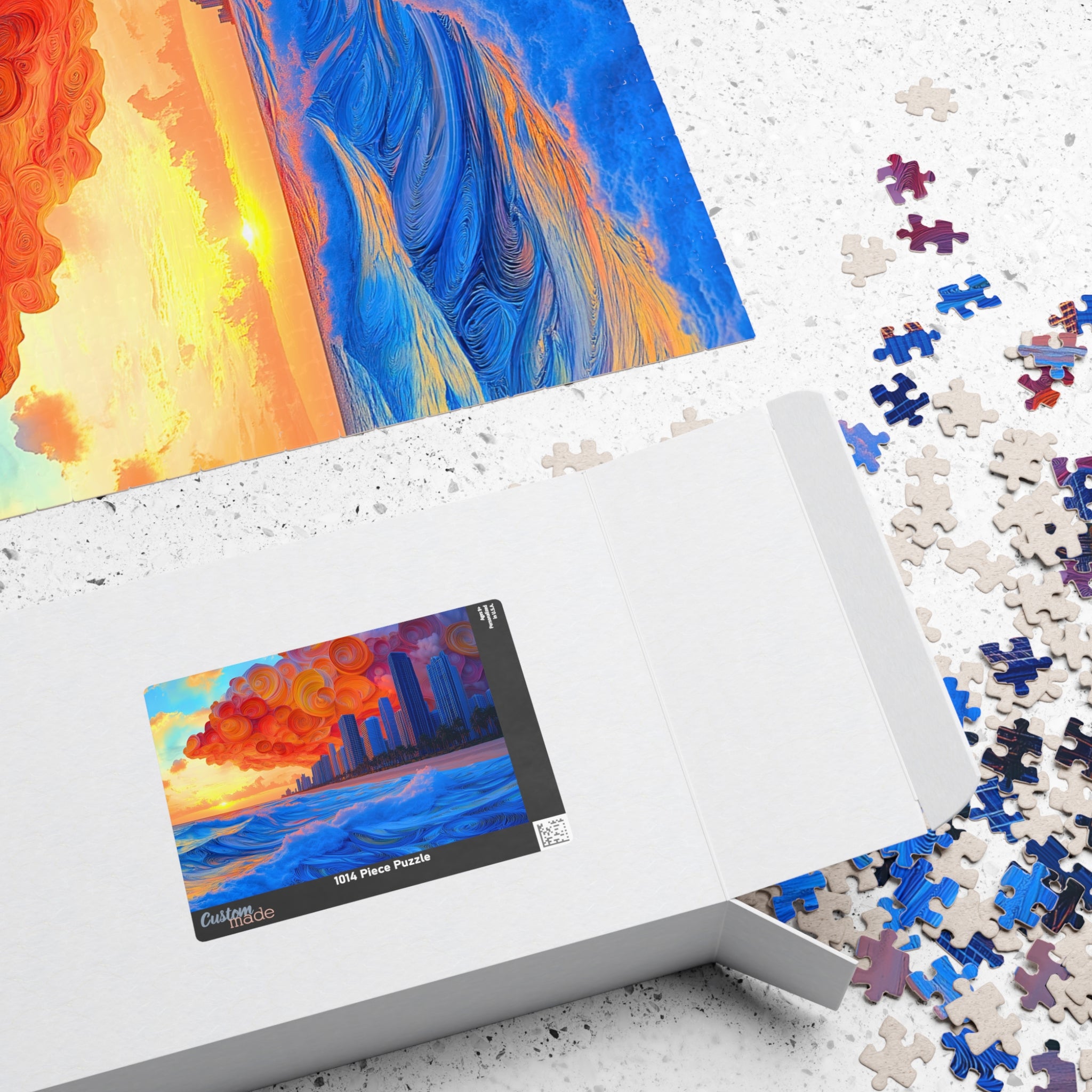 Box design of the Swirling Beach 1014 Piece Art Puzzle by Printify, showing the beautiful sunset skyline artwork alongside scattered puzzle pieces.