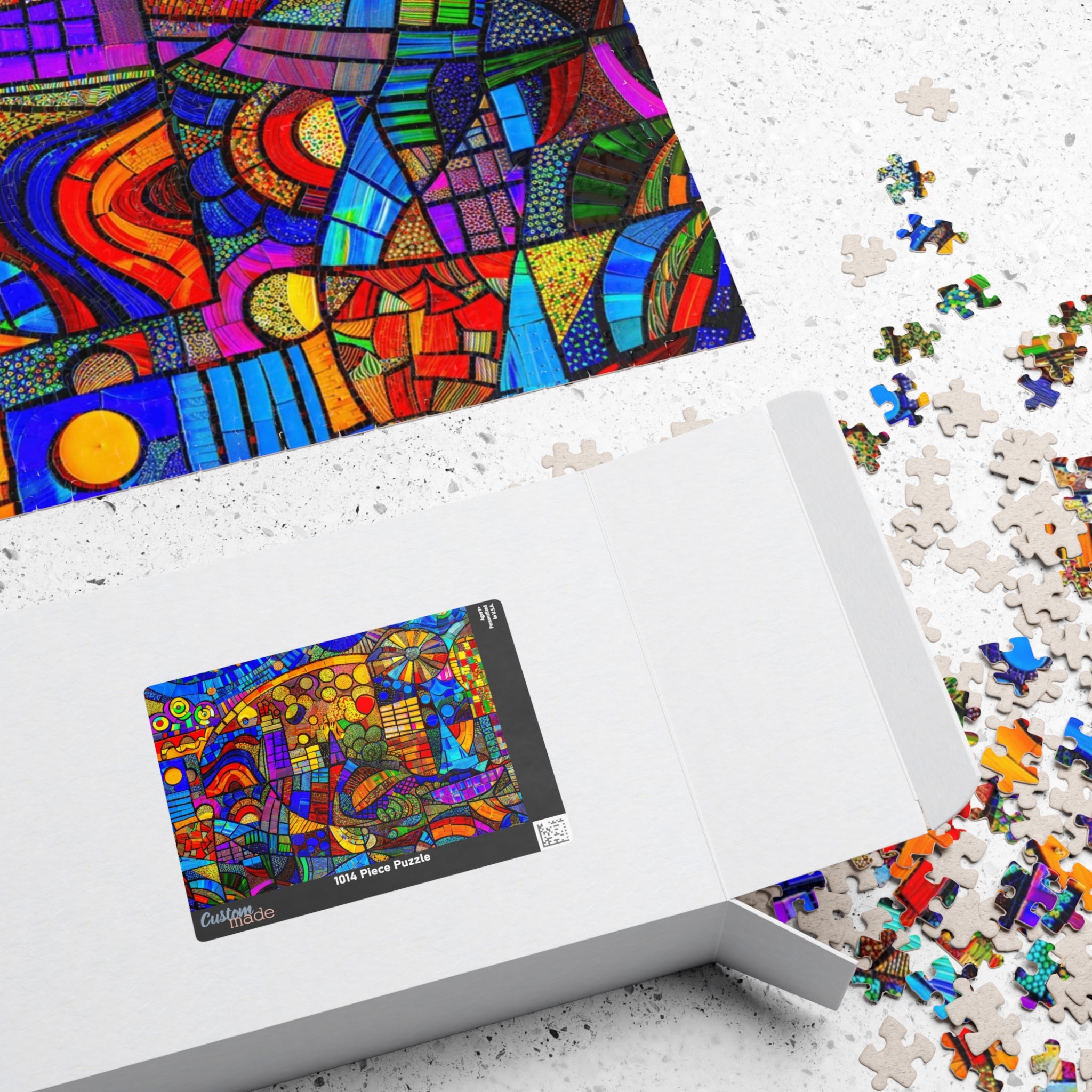 Open box of the Ultra Abstract 1014 Piece Art Puzzle by Printify with puzzle pieces scattered, highlighting the colorful artwork on the puzzle.