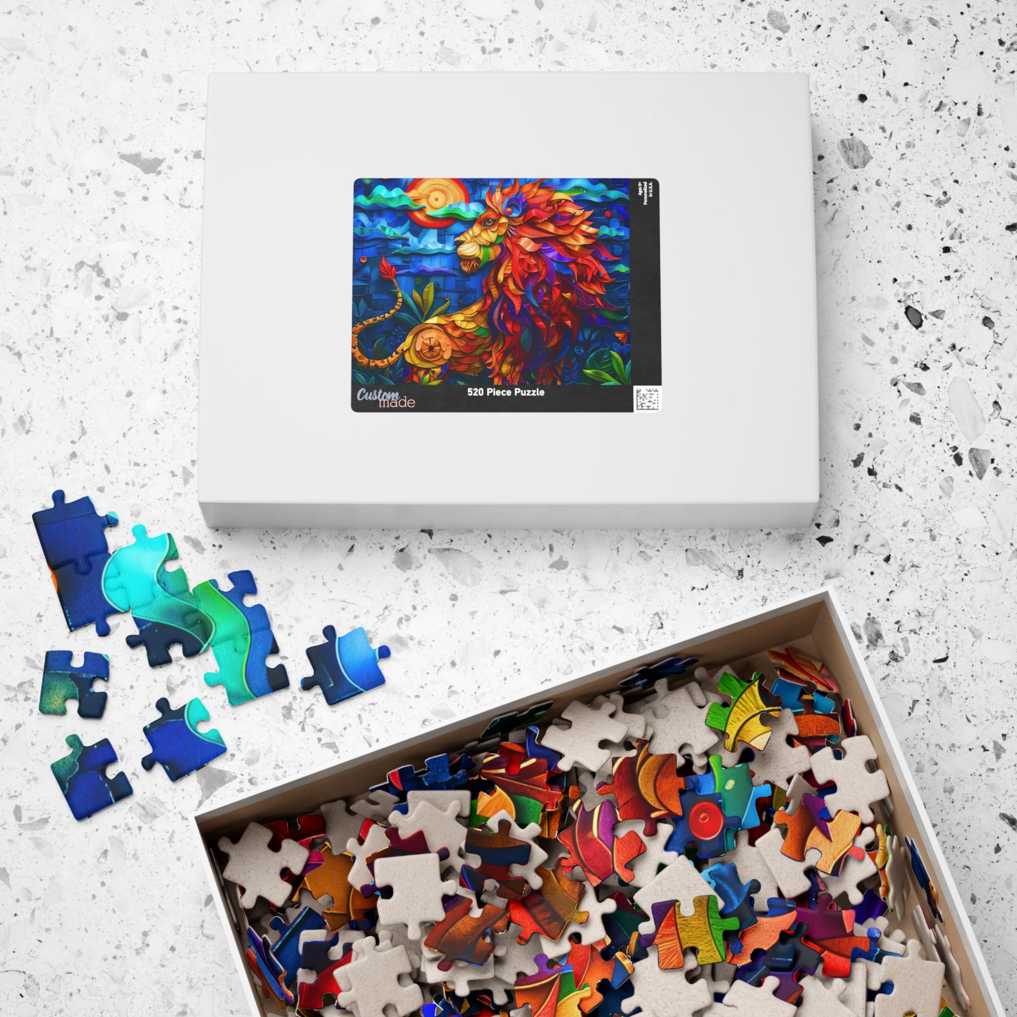 The packaging of the Colorful Lion puzzle by Printify, featuring a vibrant lion image on the box and assorted puzzle pieces spilling out, showcasing the artful design.
